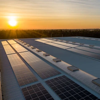 Japanese contractors install solar panels on the Public Works building roof  at Fleet Activities Sasebo, Japan